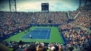 US Open tennis match packed stadium blue court